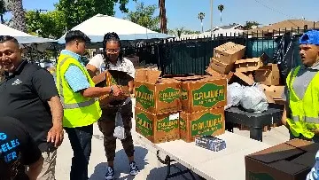 Neighbors in line at an Eat Manna grocery distribution