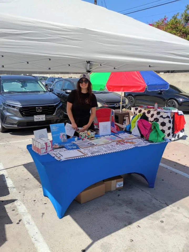 Healing Bridges outreach table under a canopy at a community resource fair